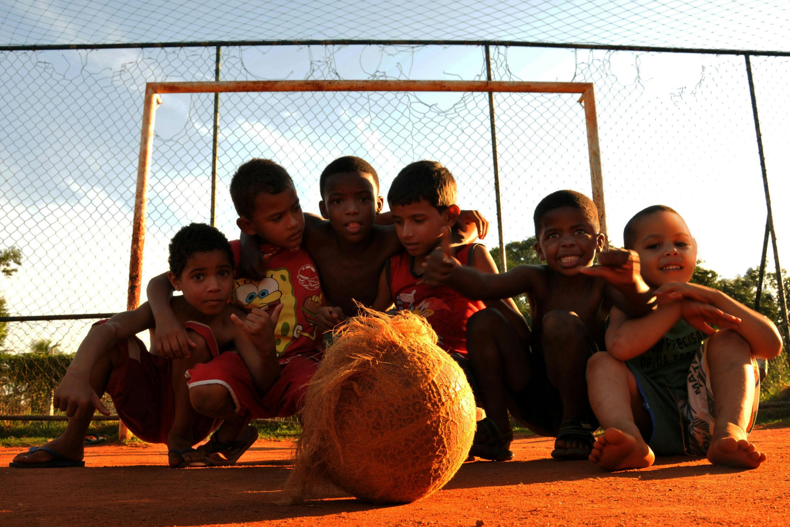 about-01 Group of kids enjoying a lively game of soccer in a Rio de Janeiro neighborhood.