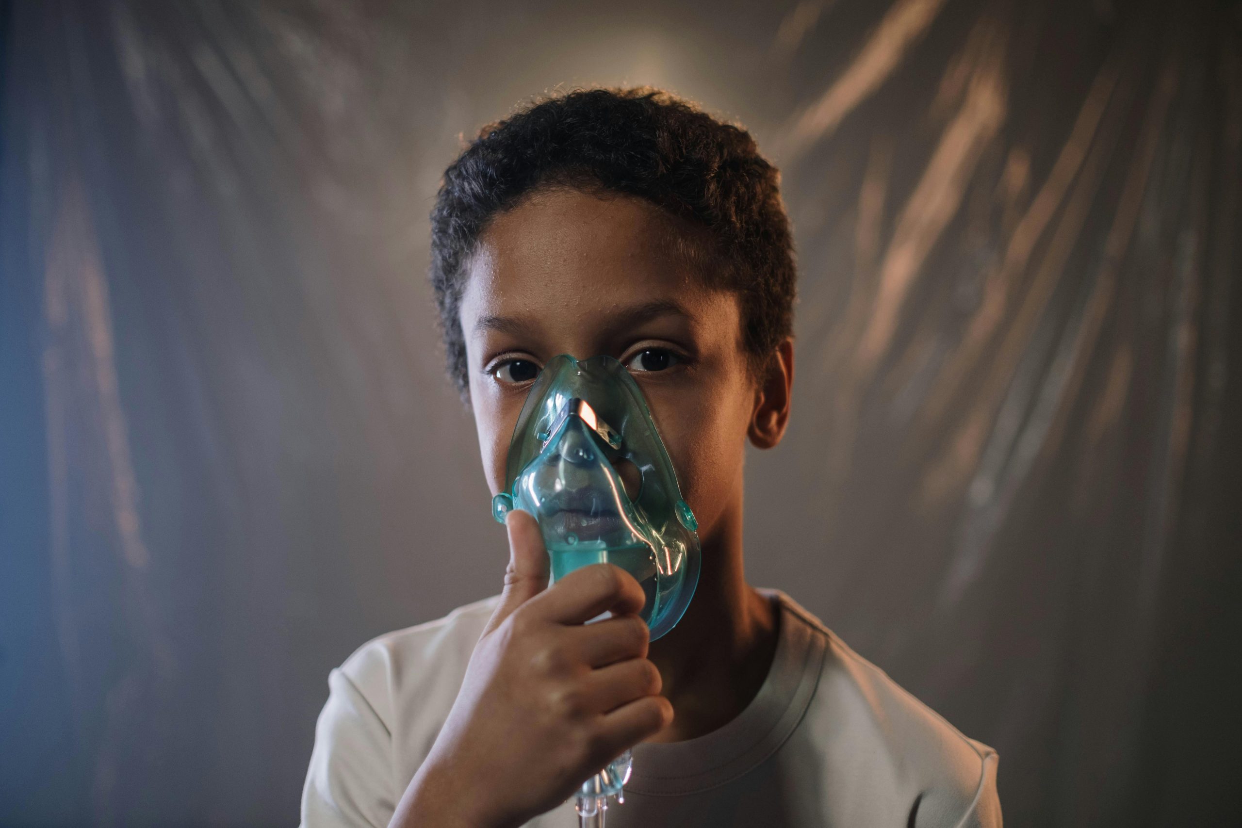 our-services-3 Portrait of a child using an oxygen mask indoors, highlighting health care needs.